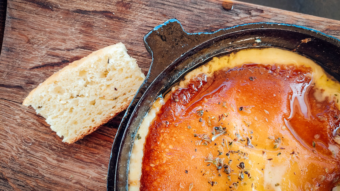 Provoleta acompañada de tostada, servida en el restaurante de la Bodega Tempus Alba.